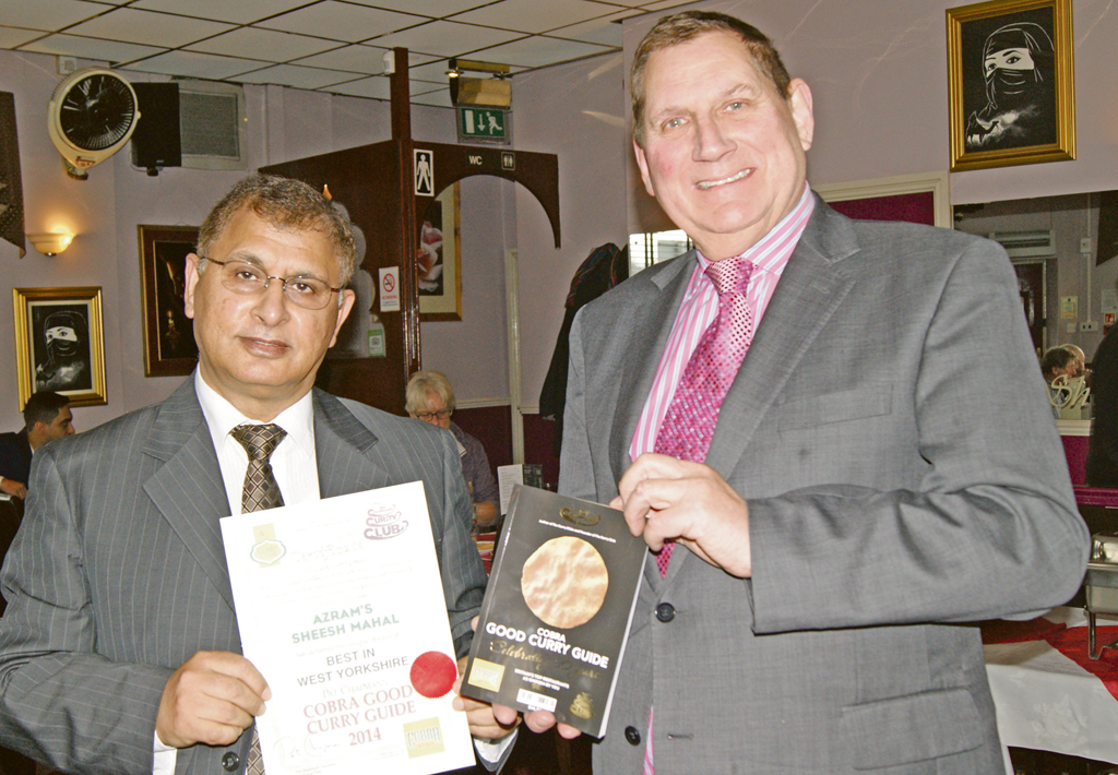 RESTAURANT: Azram’s Sheesh Mahal owner, Azram Chaudhry, receives his award for the top West Yorkshire restaurant from Good Curry Guide founder, Pat Chapman
