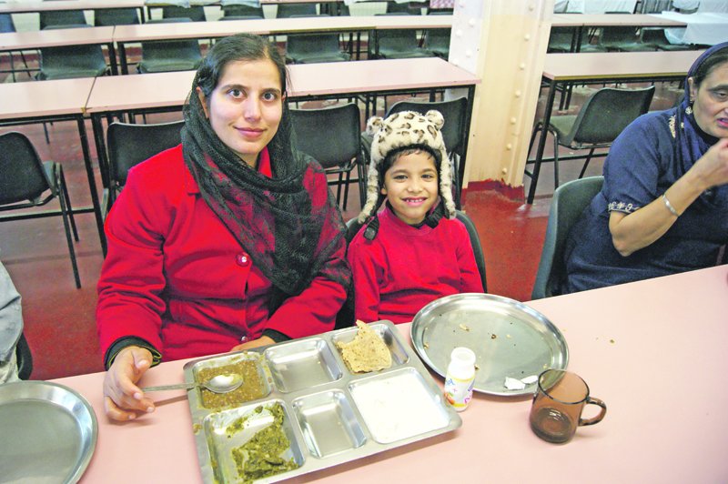 FAMILY: A mother and her son enjoy the free meal in.