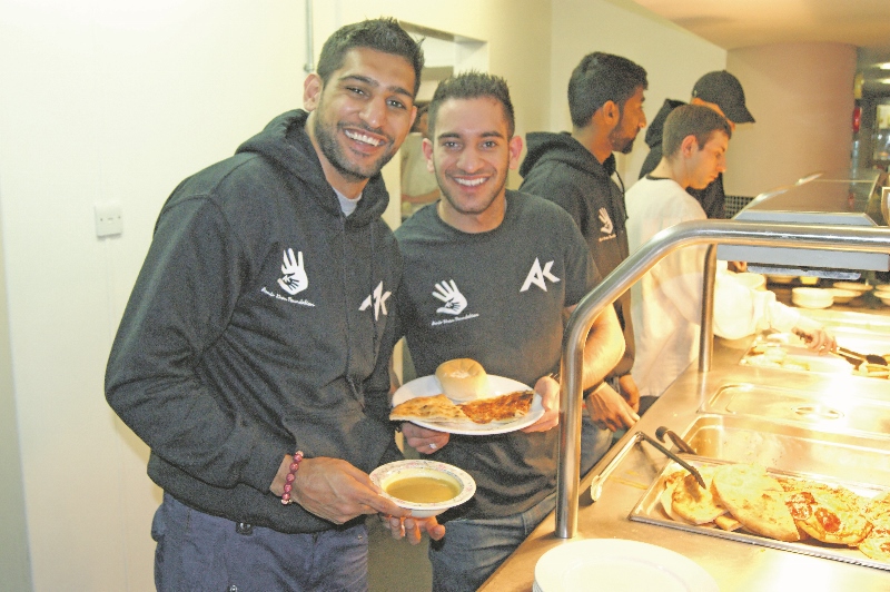 BROTHERS: Amir Khan and his brother Haroon served up food on Monday 10th February, alongside members of the Amir Khan Foundation