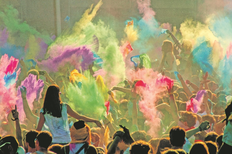 COLOUR: Powder is thrown into the air as colour overtakes the Holi celebrations