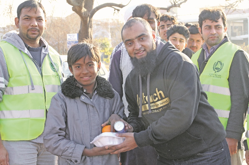 CHARITY: InTouch Foundation founder and board member, Osman Gondal, helped deliver meals to young and old in some of Pakistan’s slums