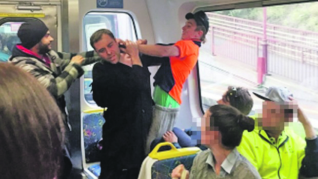 ATTACKED: 36-year-old Jason Cias (centre) is assaulted by the man wearing orange after defending three women