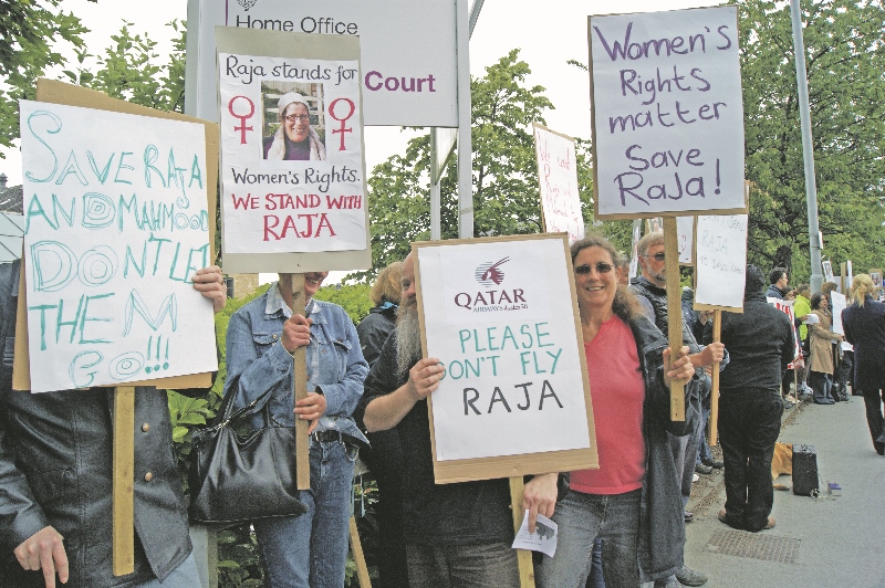 Signs, appealing for an end to the potential removal of Raja and Mahmoud from the UK, were held by supporters