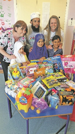 SMILES: W-Childcare members delivered gifts to the Bradford Royal infirmary on Monday (pictured front row, l-r) Zainab Qureshi, Amina Qureshi, Raza-ul-Mustafa, (back row, l-r) BRI Senior Play Specialist, Alison Kay; W-Childcare Director, Nazim Ali; W-Childcare Manager, Michaela Yildiz