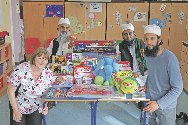 GIFTS: NADA’s chairman Amjad Aslam, General Secretary, Nazim Ali, and executive committee member, Mohammed Aslam, handed the presents over to Bradford Royal Infirmary’s senior play specialist, Alison Kay