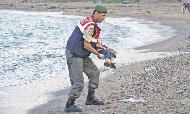 TRAGIC: The image of a lifeless child being carried off a Turkish beach shocked the world last week