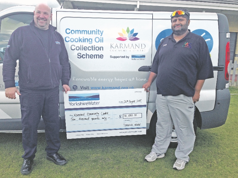 HANDOVER: Duncan Woodhead, Network Protection Technician at Yorkshire Water presents a cheque to Karmand Community Centre’s Nasa Hussain which will help roll out the ‘Fats to Fuels’ project