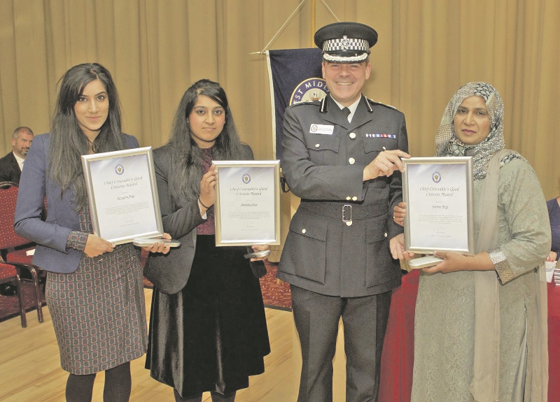 REWARD: The Baig family received their bravery awards from West Midlands Police deputy chief constable Dave Thompson after tackling a street robber in Wolverhampton last year