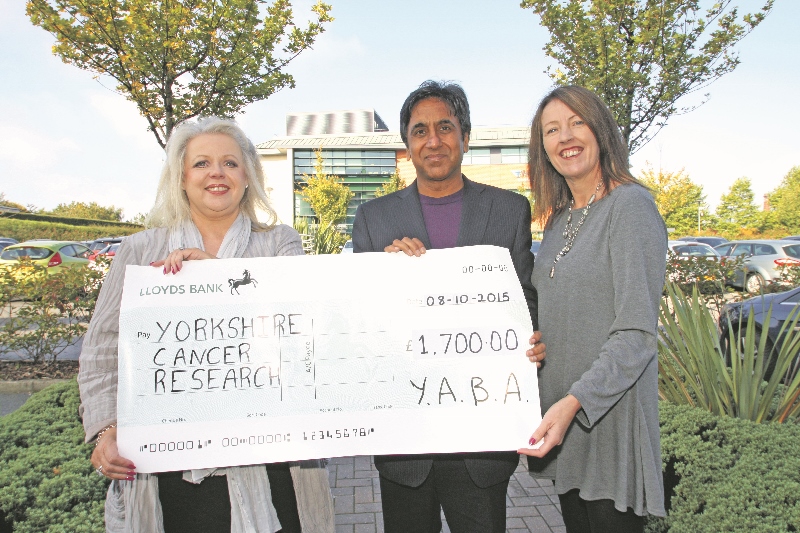Amarjit Singh, Chairman of the Yorkshire Asian Business Association, presents a cheque for £1,700 to Sally Crerar, Head of Community Fundraising, and Julia Clark, Director of Fundraising at Yorkshire Cancer Research