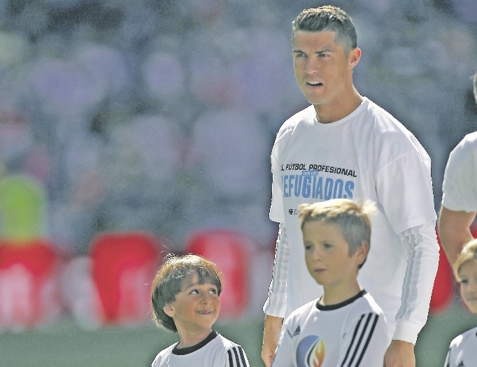CLASS: Cristiano Ronaldo was accompanied by Syrian refugee, Zaid Mohsen, as he entered the pitch for Real Madrid’s tie with Granada earlier this month