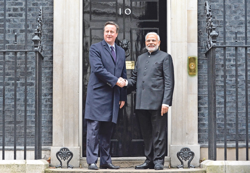 OFFICIAL VISIT: British Prime Minister David Cameron greets Prime Minister Narendra Modi of India