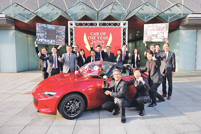 CHEERFUL: Mazda MX-5 chief engineer Nobuhiro Yamamoto leads his designers, engineers and media team in celebrating the roadster’s car of the year victory