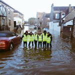 SUBMERGED: Kids help in the clear up of York after record-breaking rains cause untold damage (Pic credit: 121 tuition)