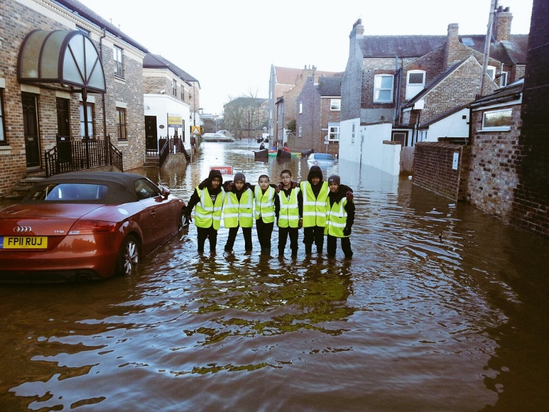 SUBMERGED: Kids help in the clear up of York after record-breaking rains cause untold damage (Pic credit: 121 tuition)