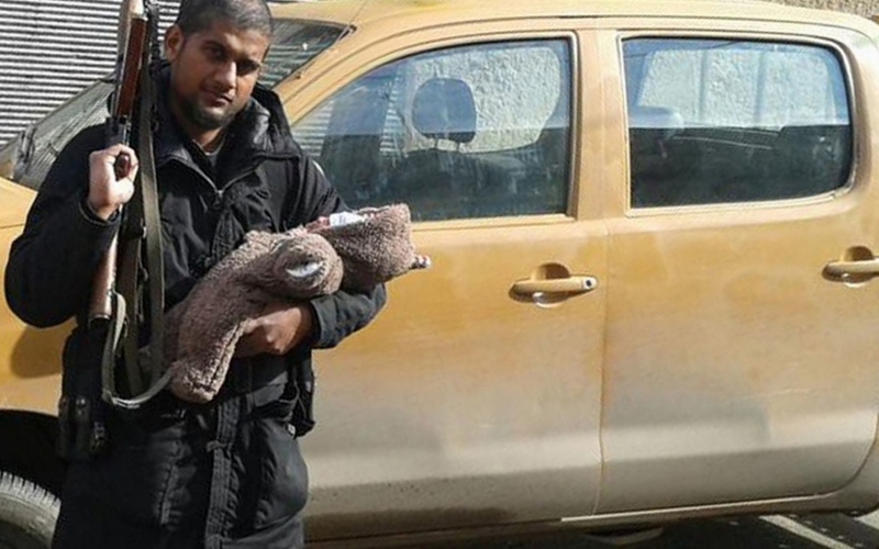 SUSPECTED TERRORIST: Siddharta Dhar, here posing with his child and a gun in Syria