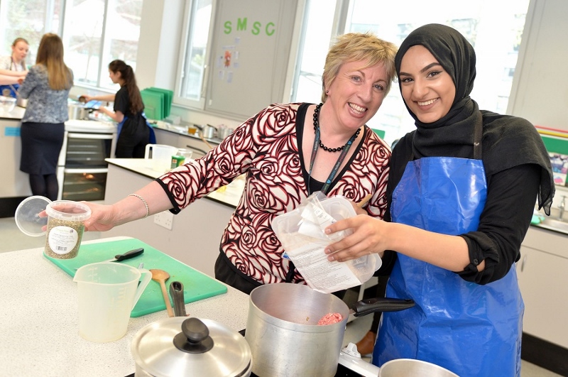COOKING TIME: Sandy Docherty and Titus Salt student, Aishah, cook up a treat in the kitchen