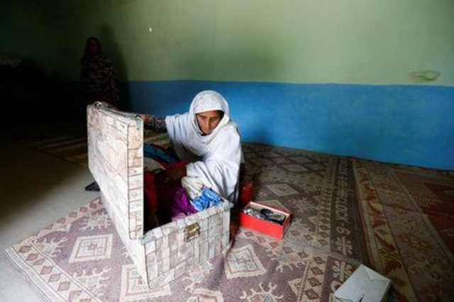 SAD: Ambreen Riasat's aunt shows her niece's belongings in their home in the village of Makol outside Abbottabad