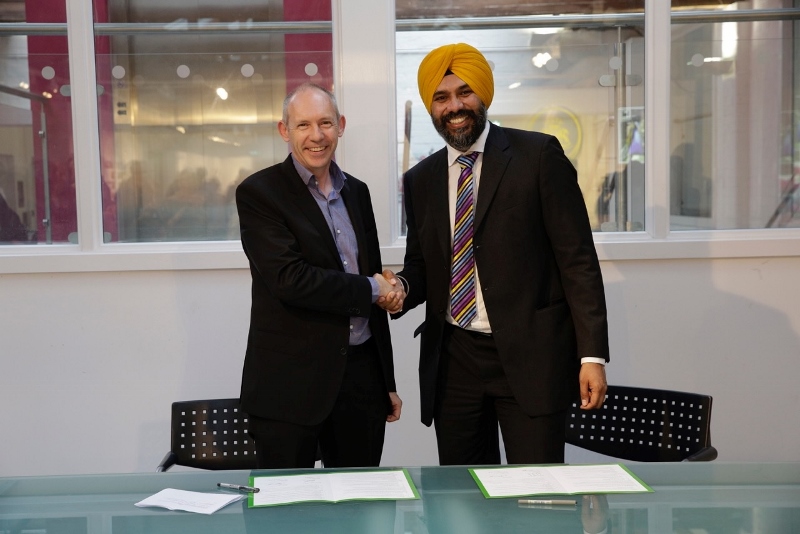 PARTNERSHIP: Bradford College Group CEO, Andy Welsh, and Kala Sangam CEO, Ajit Singh, shake hands after signing the memorandum