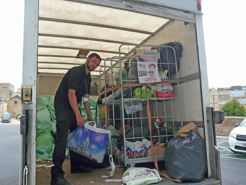 TEAM EFFORT: Bradford College staff member Anwar Khan loads donations into the van for distribution at the day shelter