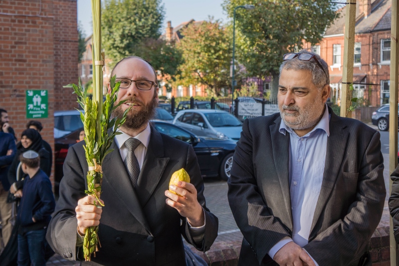 TOGETHER: Rabbi Baruch Levin and Sayed Yousif Al-Khoei OBE stand with the newly constructed Sukkah