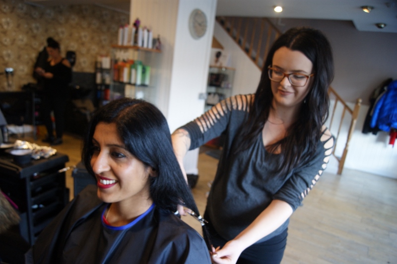 IN THE CHAIR: Aisha watches as a hairdresser gets to work
