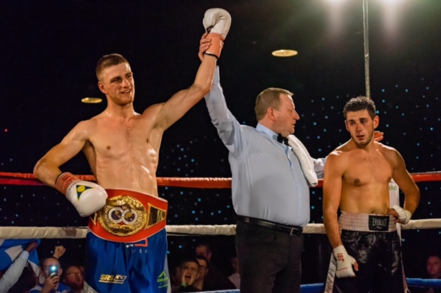 DREAM TEAM: Reece Cartwright celebrates his defence of the IBF Youth World Middleweight Championship alongside advisor, Rick Manners (left), and promoter, Dennis Hobson (right)