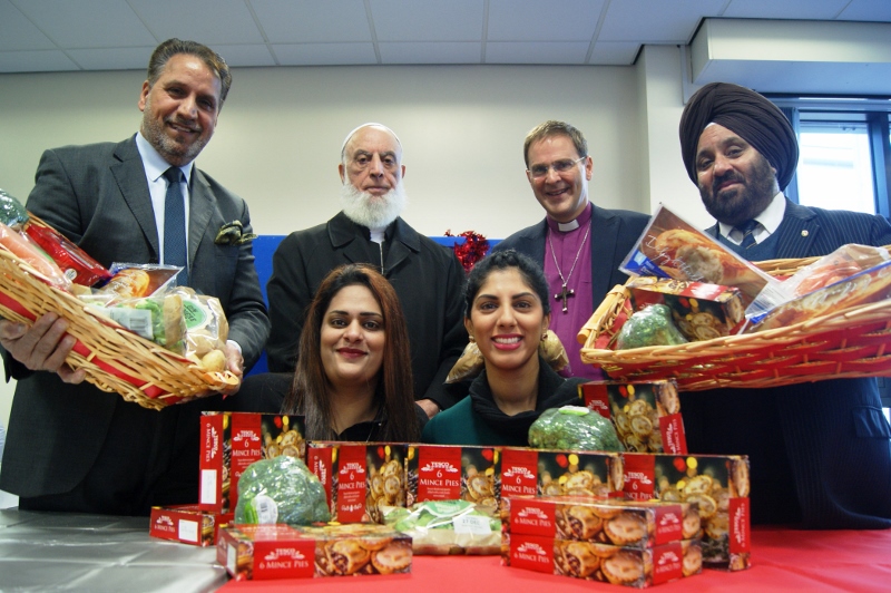 UNITED: The multifaith team packed and distributed Christmas hampers with al the trimmings (l-r, back row) Council for Mosques President, Rafiq Sehgal; Khidmat Centre Board of Directors Chairperson, Sher Azam; Bishop of Bradford, Rt Rev Toby Howarth; Yorkshire Sikh Forum member, Nirmal Singh; (l-r, front row) Muslim Hand Volunteer, Rabia Azhar, and Community Development Co-ordinator, Sofia Buncy