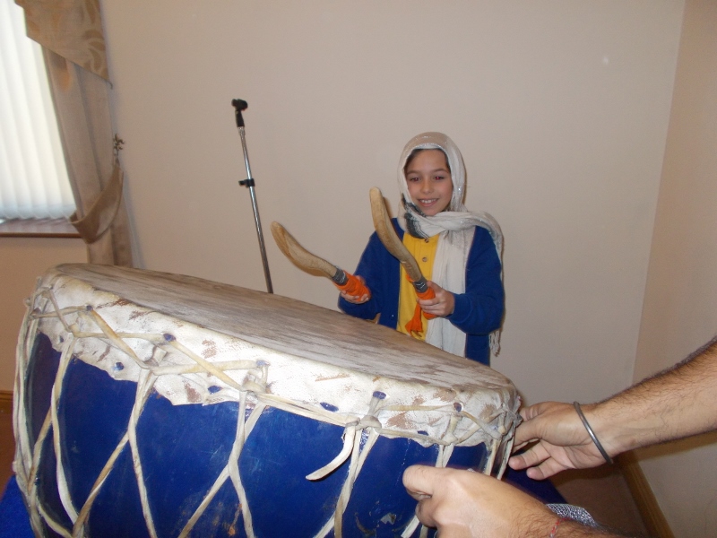 MAKING MUSIC: Children tried their hand at traditional Sikh instruments at the temple