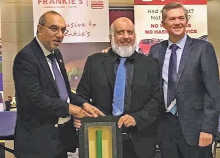 DELIGHTED: Hanif Mayet and Abdul Ravat received an engraved bat commemorating a match at Headingley from Mark Arthur