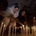 TRIBUTES: Pakistani women pay tribute to the 88 victims who lost their lives at the much-loved sufi shrine