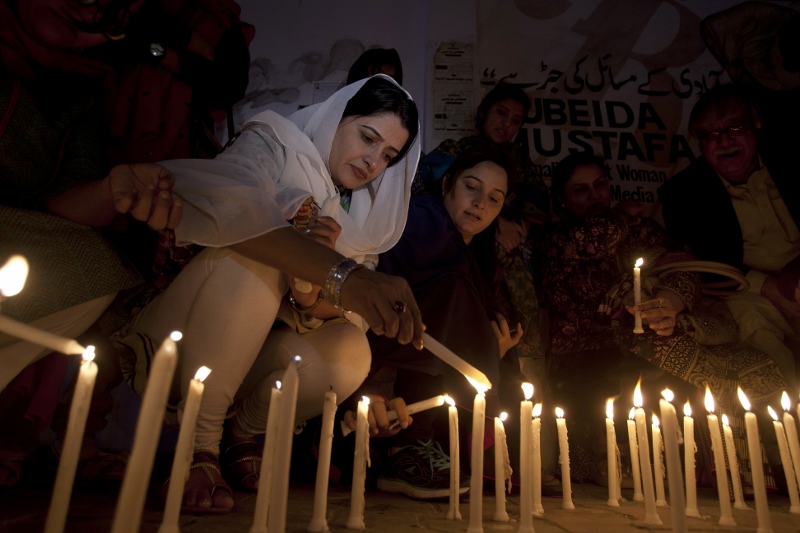 TRIBUTES: Pakistani women pay tribute to the 88 victims who lost their lives at the much-loved sufi shrine
