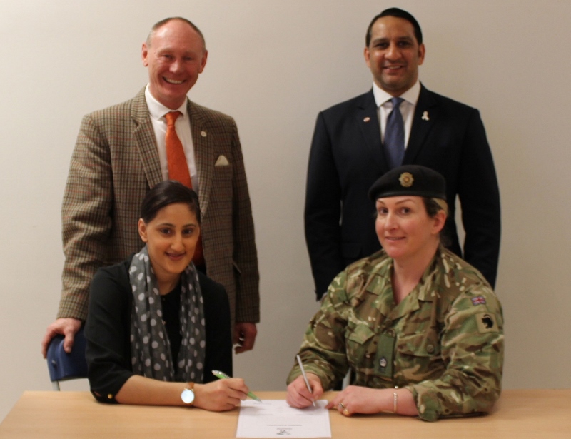 SIGNING: Halima Khan and Irkam Butt signing the Armed Forces Covenant with Major Lisa Marr and Richard Lenton