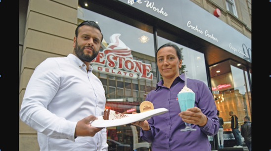 PROUD: Kuljit Morris, store manager and Taj Ali, co-company owner outside the front of the award winning shop