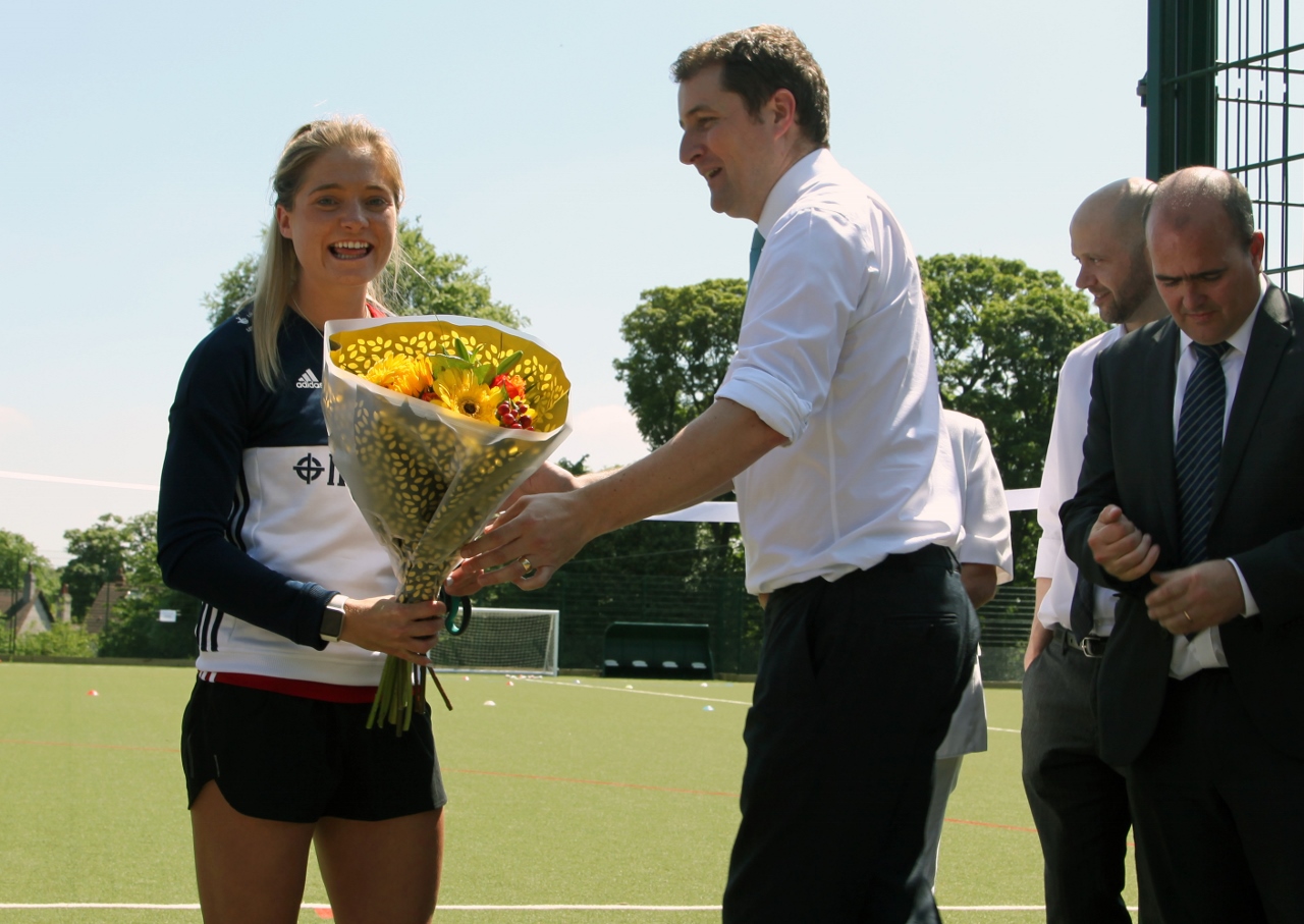 Great Britain hockey star Suzy Perry is presented with a bouquet by Roundhay School Headteacher Matthew Partington