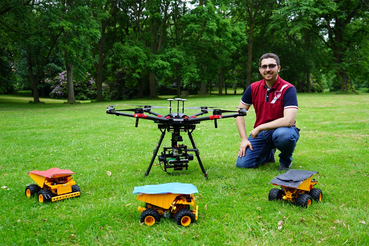 Dr. Bilal Kaddouh pictured with some of the robots that he uses