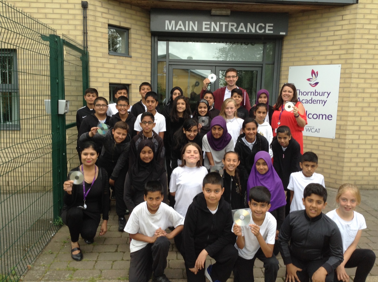 The Year 6 class and their CD with teacher Mr Raistrick, head teacher Clare Daddy (back, right) and teaching assistant Punam Sharma