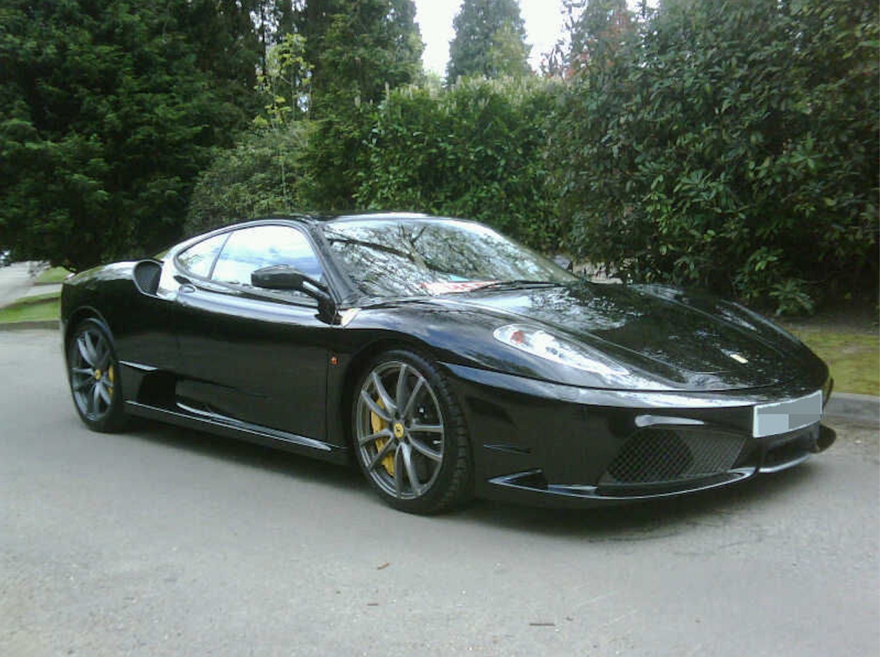 Sarju Popat traded in luxury cars, like the Ferrari F430 Scuderia pictured